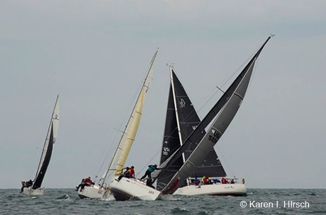 Racing sailboats approaching the mark roundgin.